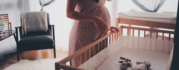 Pregnant mom in baby nursery